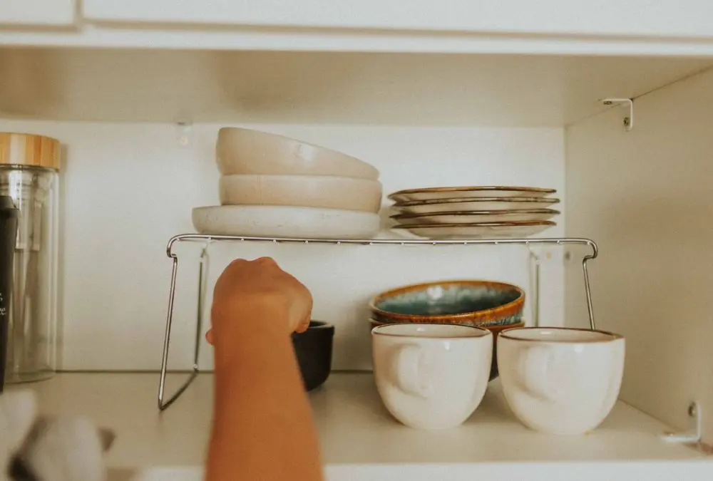 Small kitchen storage products: a wire shelf riser doubling usable cabinet height