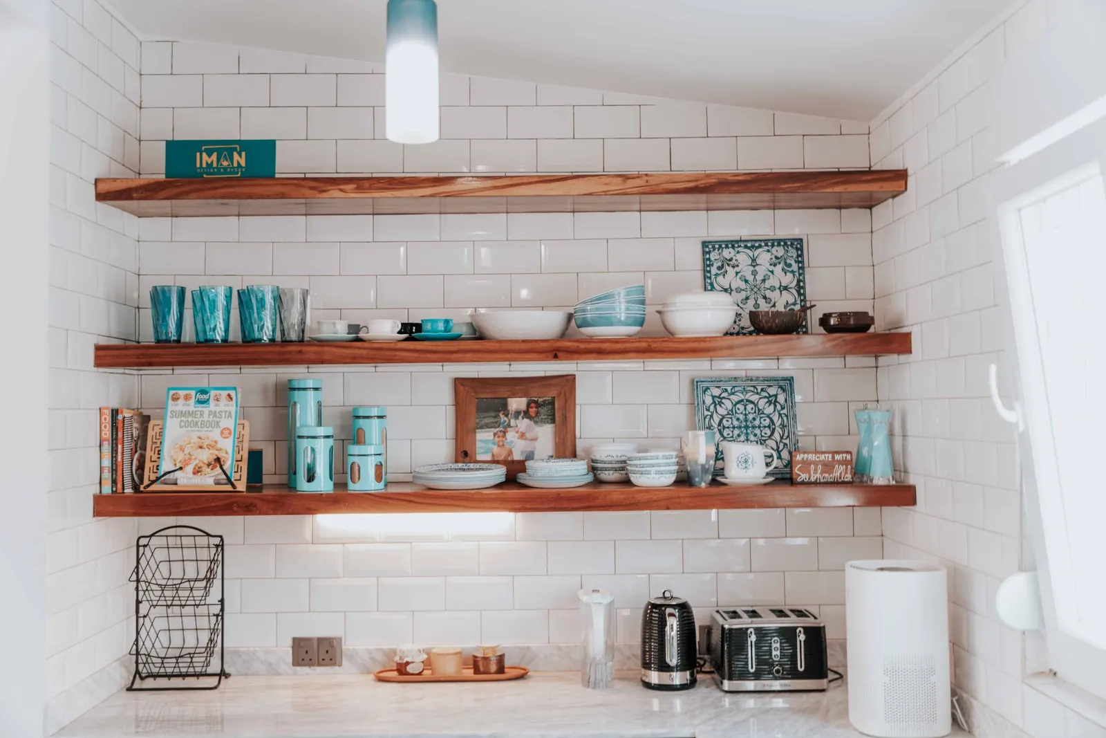 Open wall shelving used to reclaim vertical space in a small kitchen