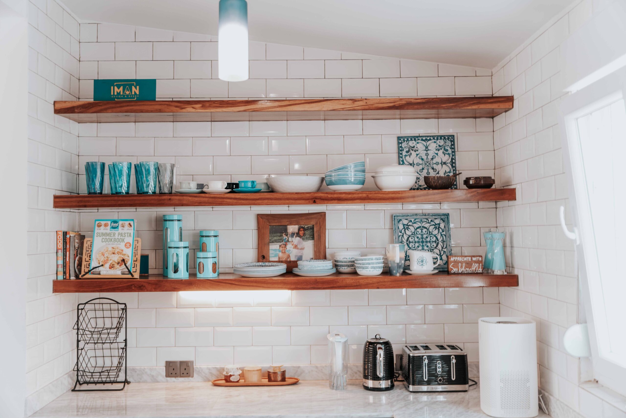 Open wall shelving used to reclaim vertical space in a small kitchen